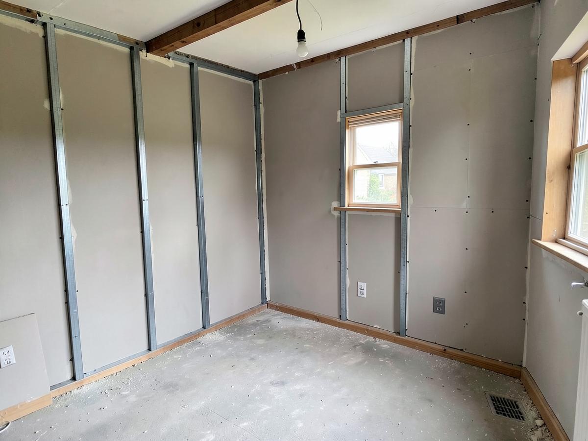 Newly plasterboarded room in a house extension ready for skimming